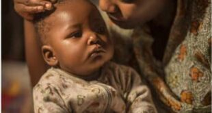 Nigerian nursing mother checking newborn baby temperature during rainy season