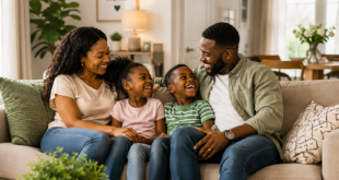 Mother, father and their two children in a happy home.